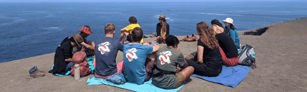 people sitting in a circle on the ground