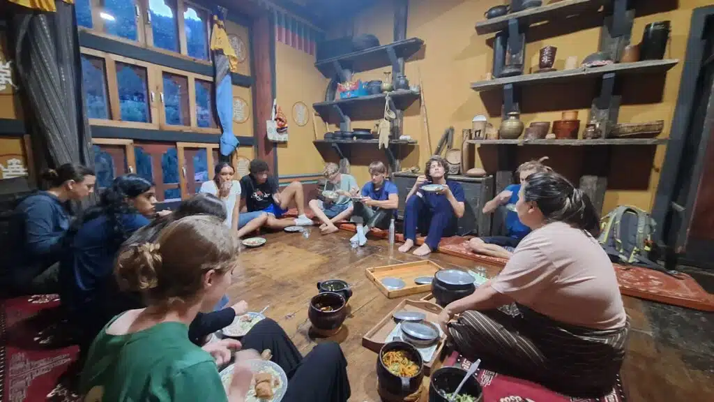 people sitting on floor having dinner in circle