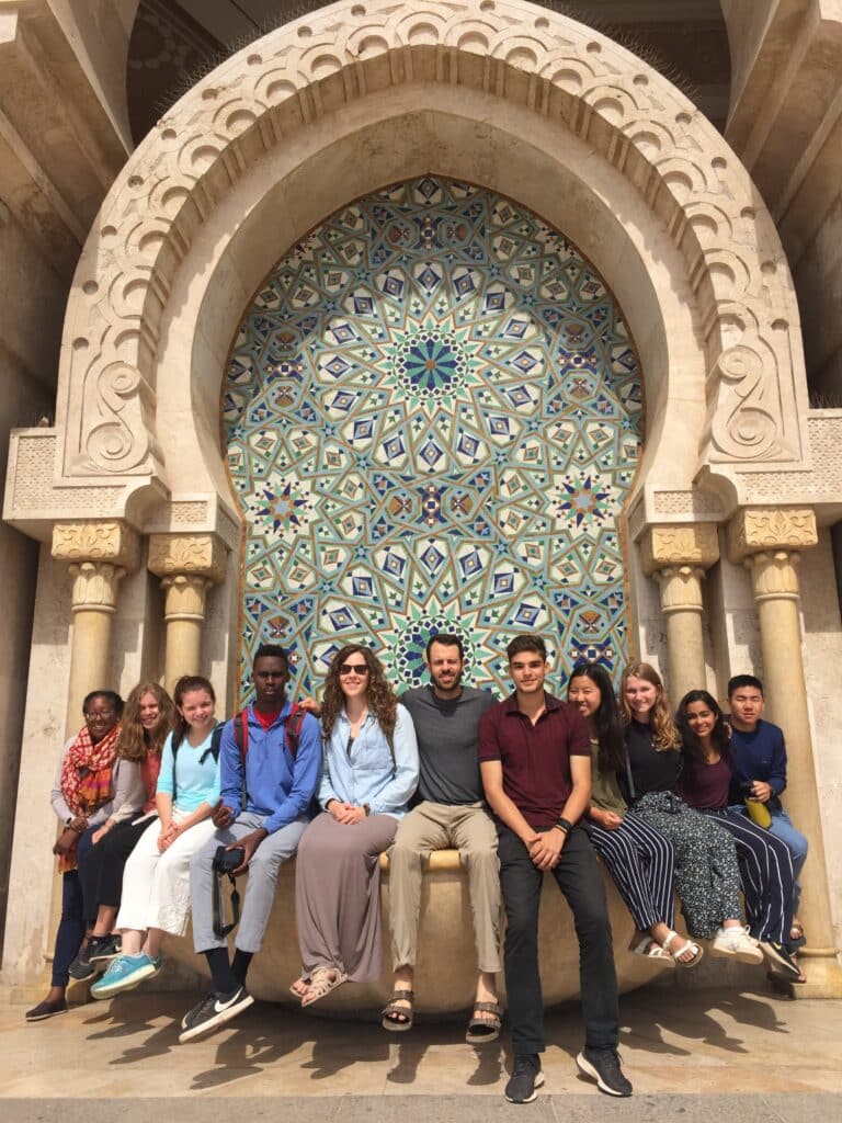 group posing in front of mosaic
