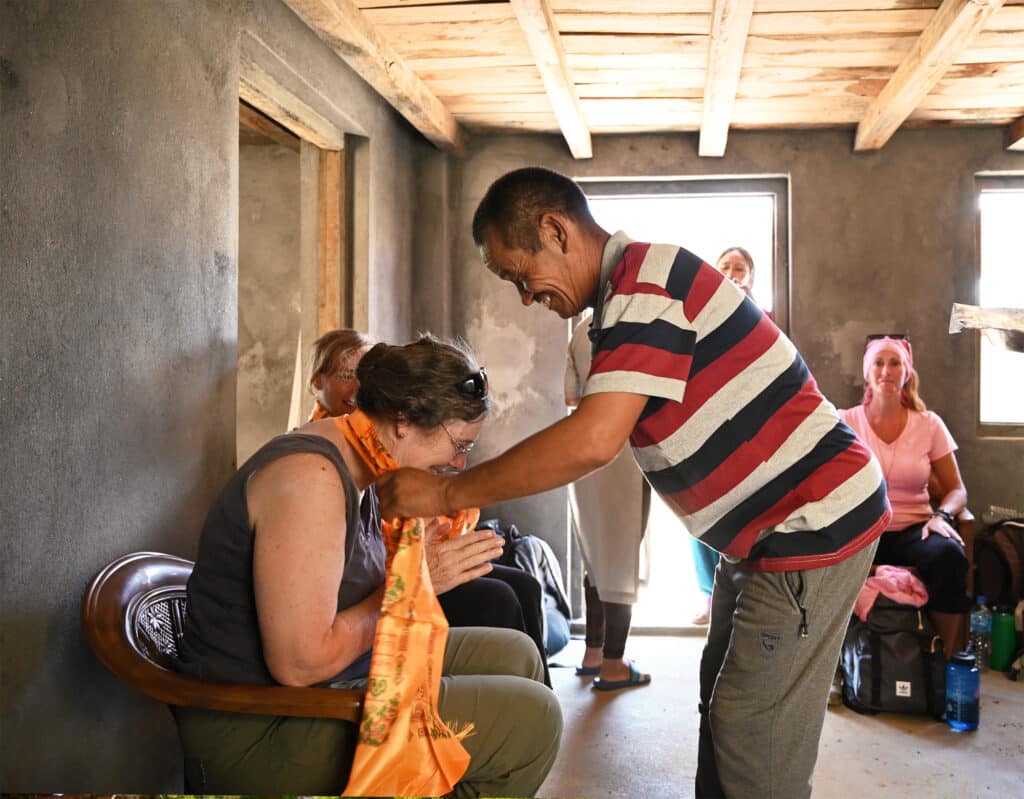 man putting scarf on woman