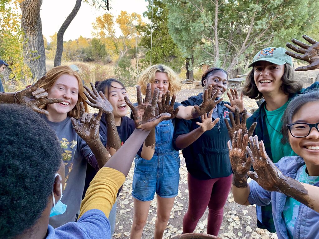 people posing with dirt on their hands