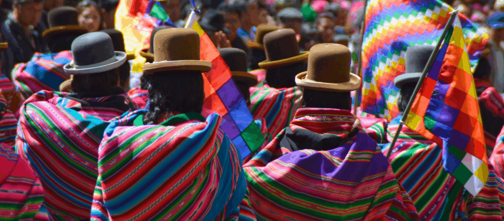 people in bright clothing and hats with backs turned away
