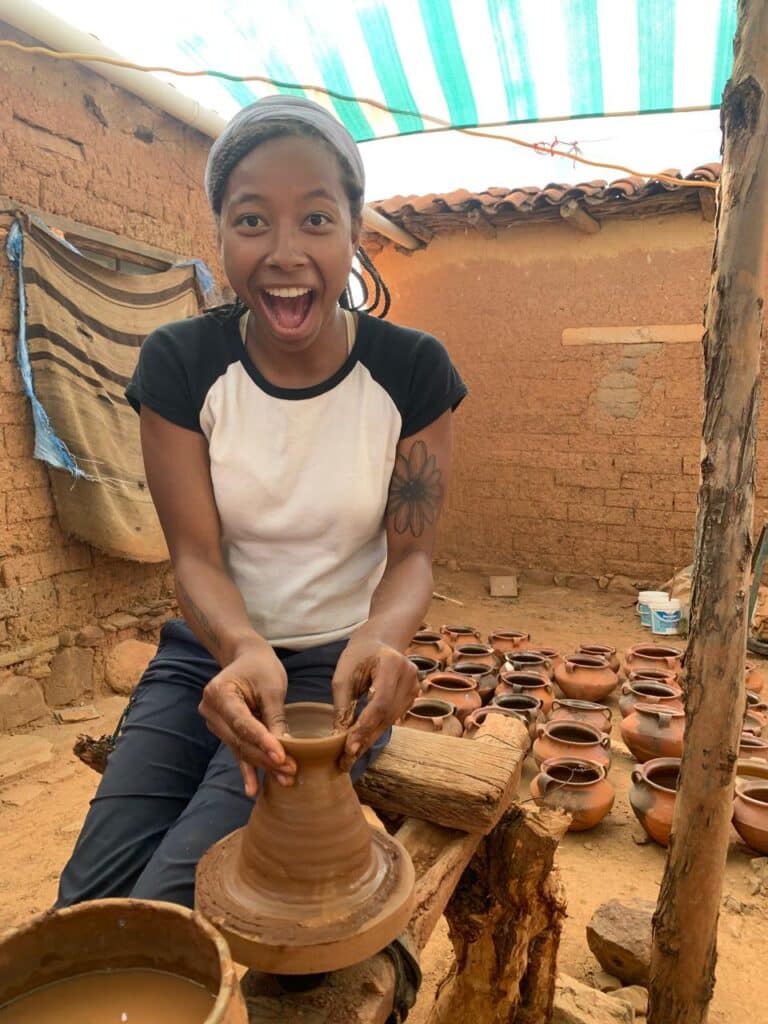 girl making pottery in mudbrick room