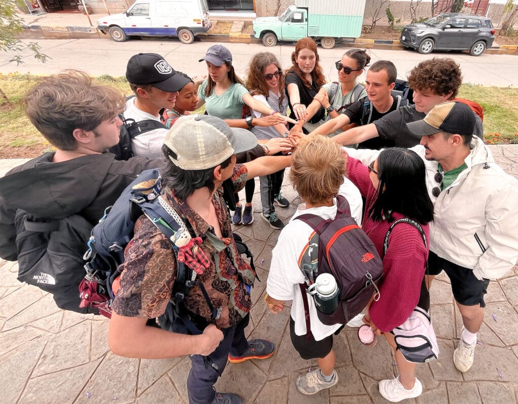 group with hands in center of circle