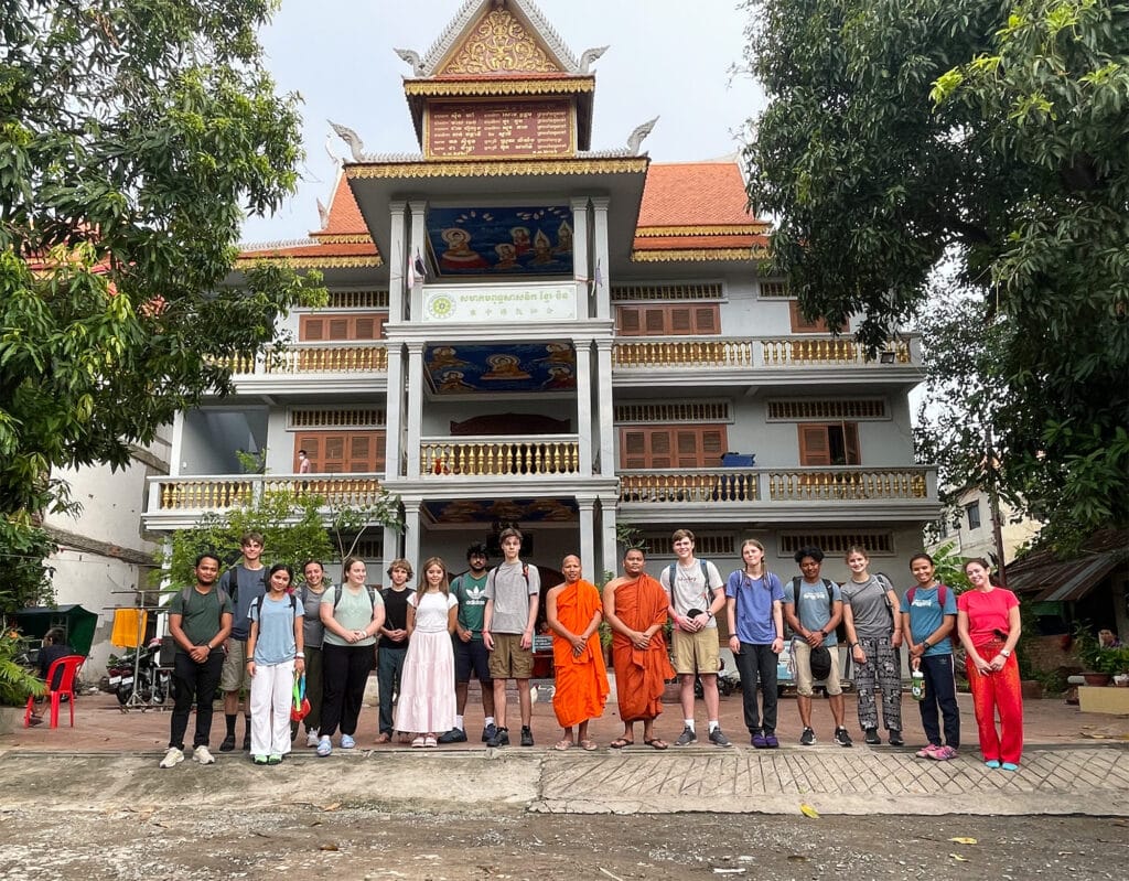 group in front of white building