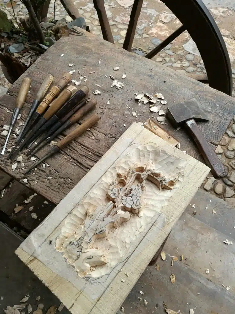 looking down on wood carving being made