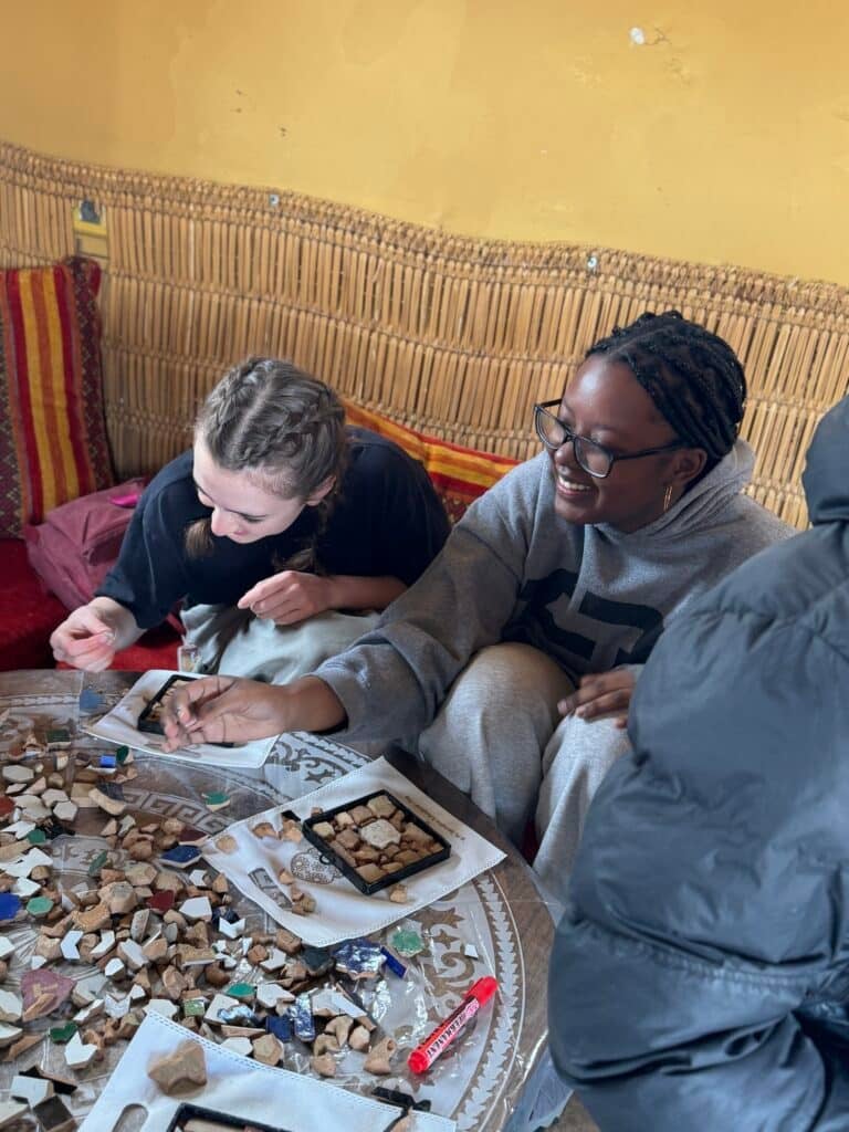 people making small mosaics