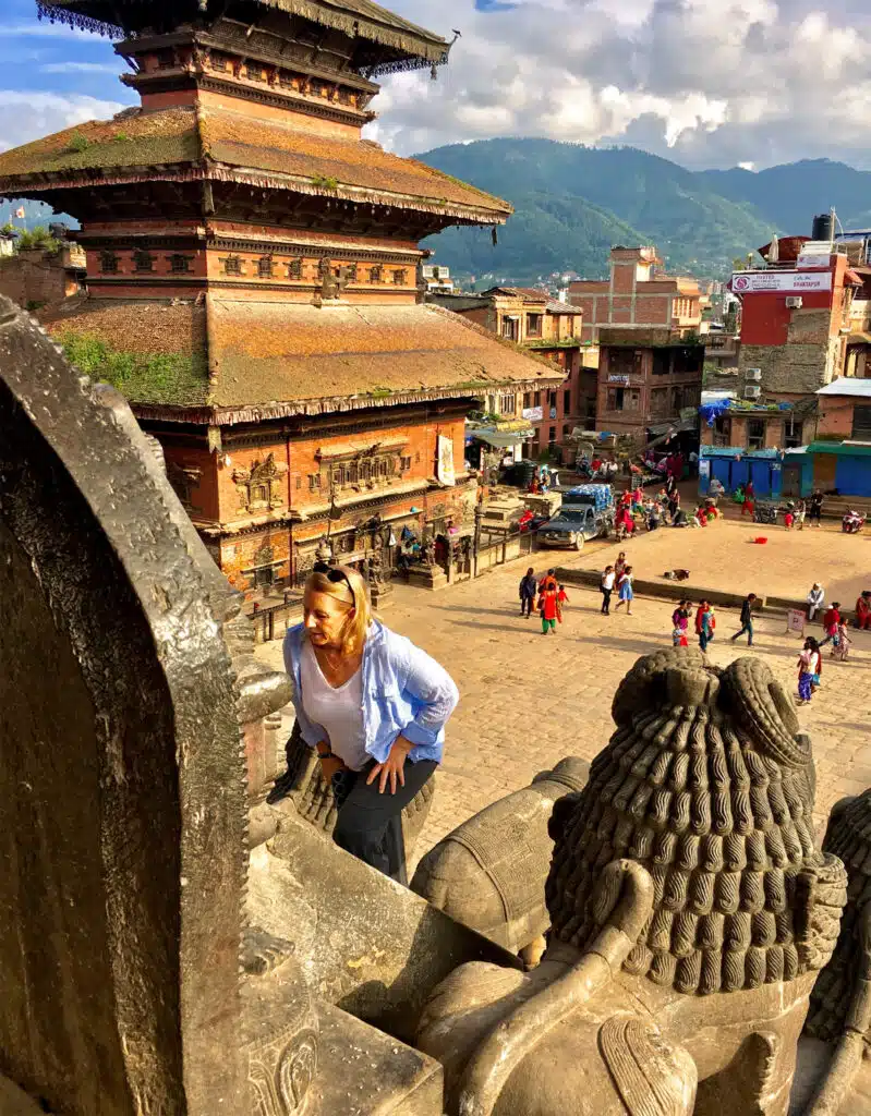 woman walking up steps of stupa