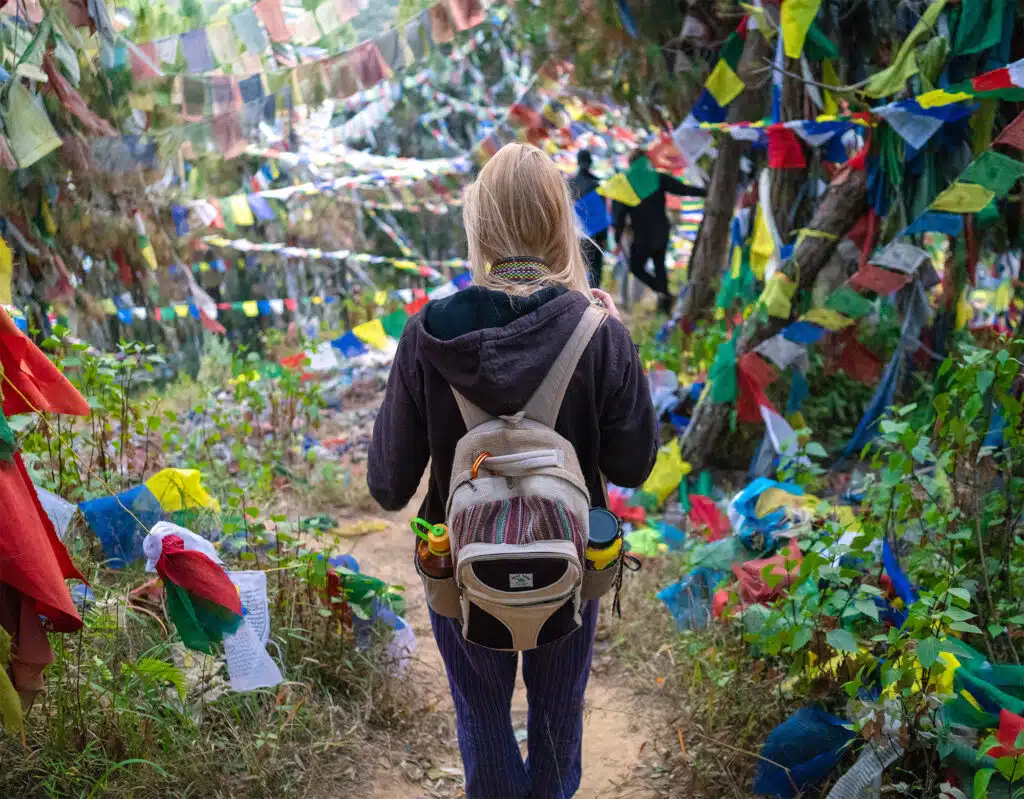 girl walking through field of prayer flags