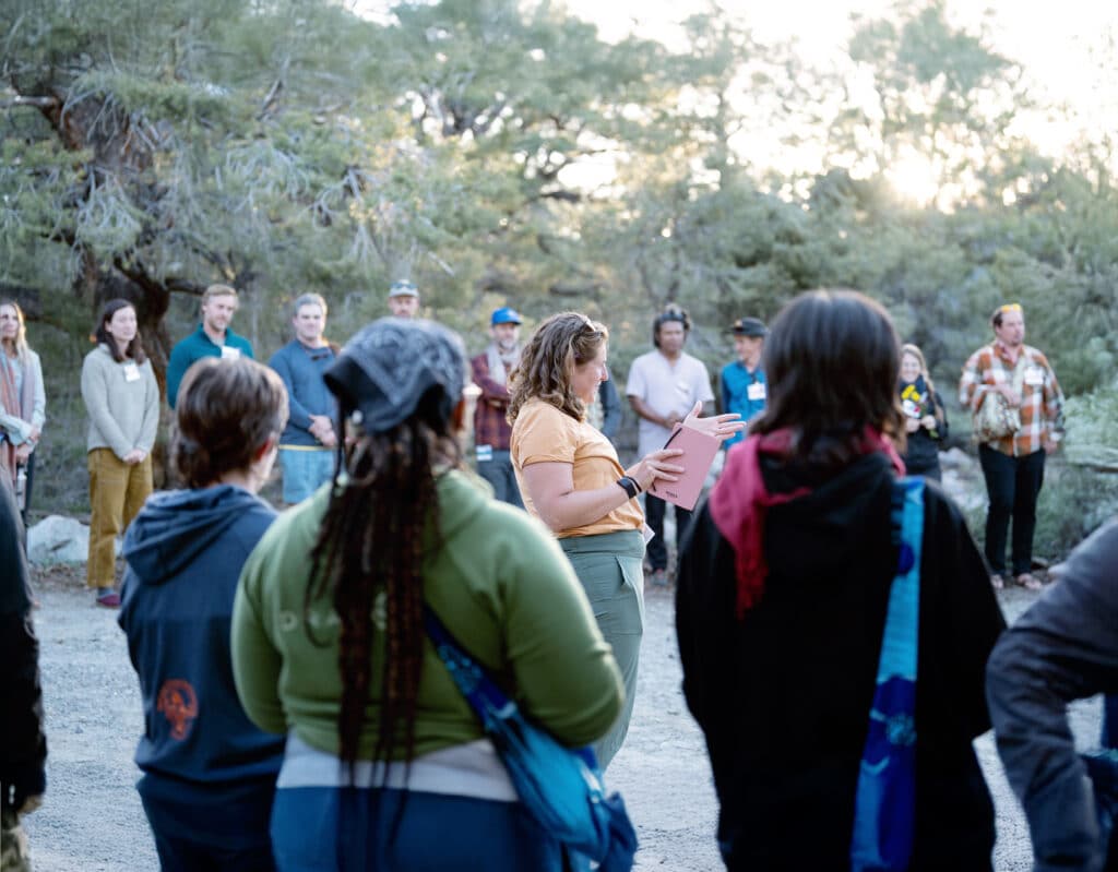 person in center of group presenting information