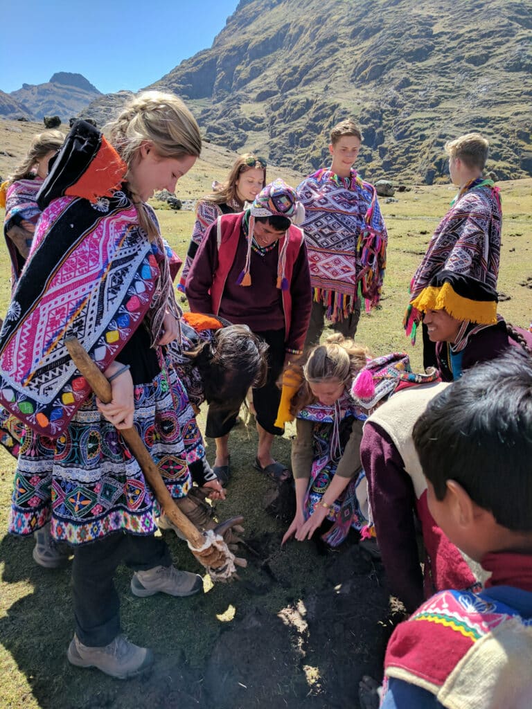 people in traditional Peru clothing working in field