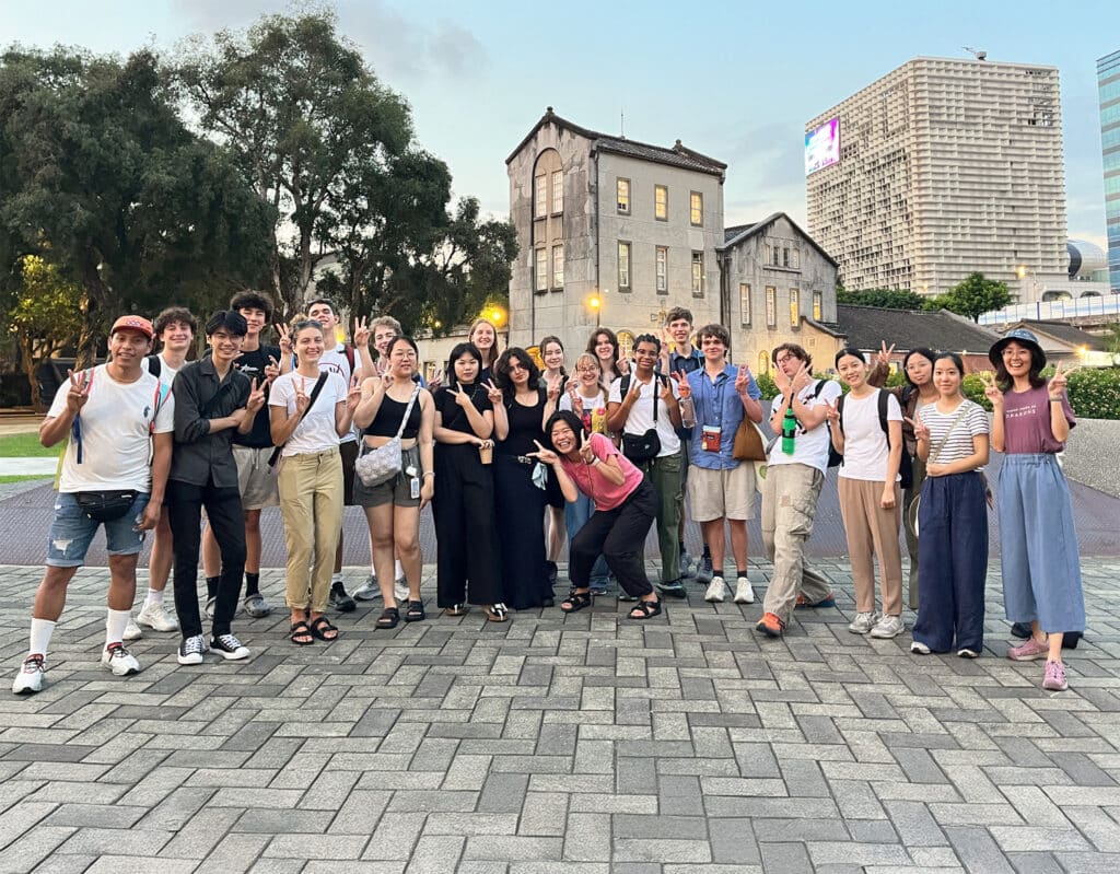 group posing in front of buildings