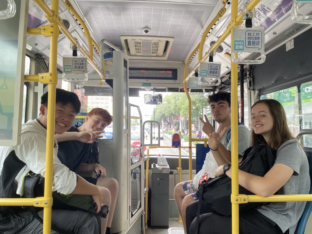 people riding bus and giving peace sign