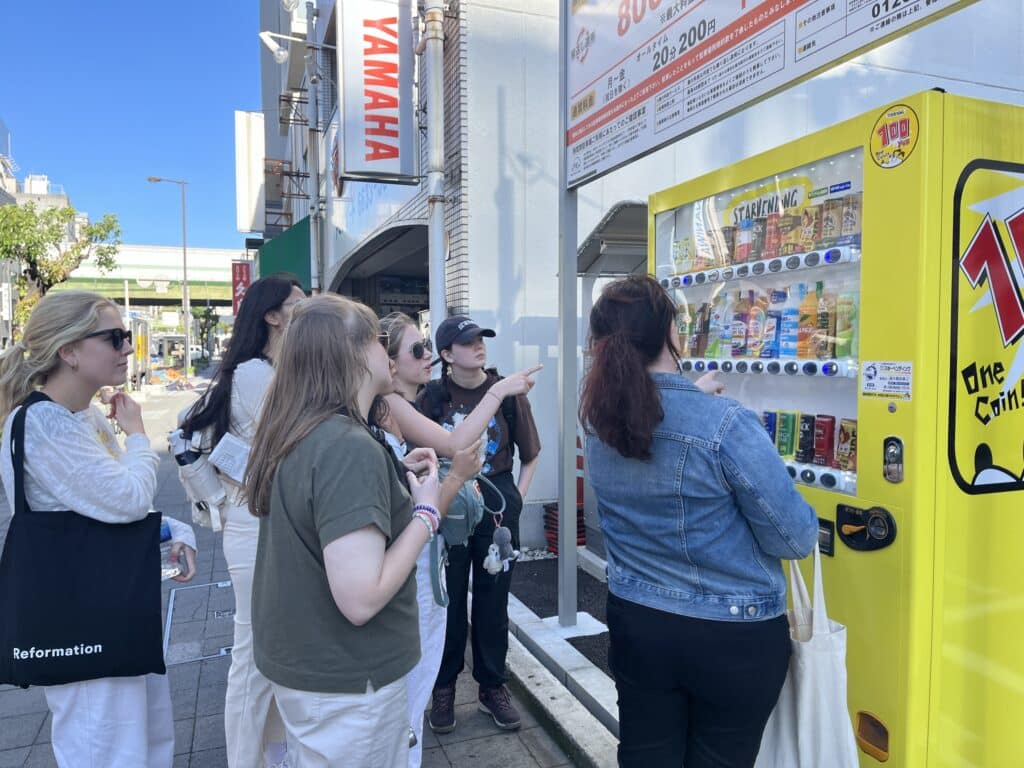 people looking at yellow vending machine