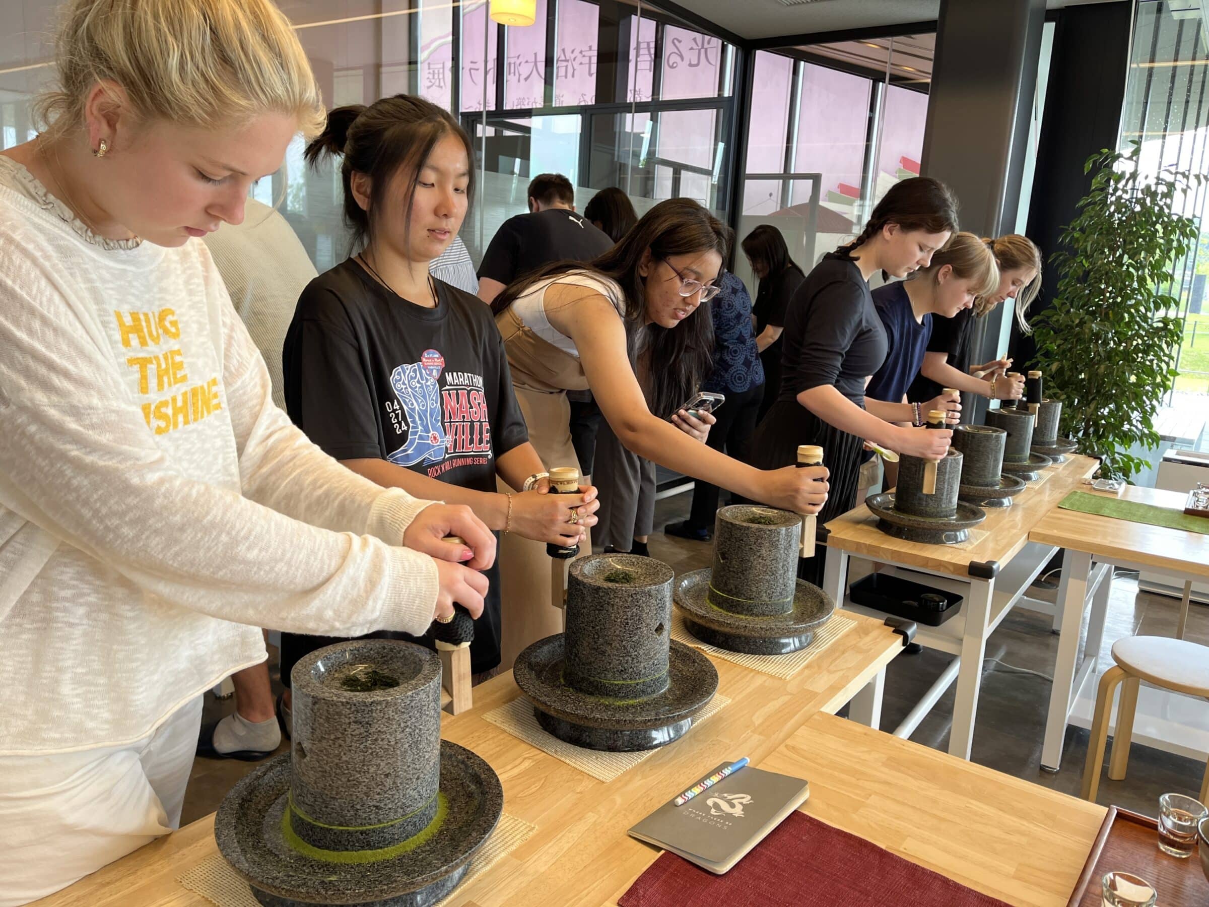 People grinding tea leaves