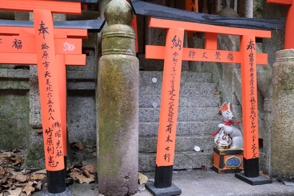 red pillars and statue by stair