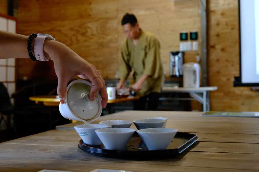 person's hand pouring tea