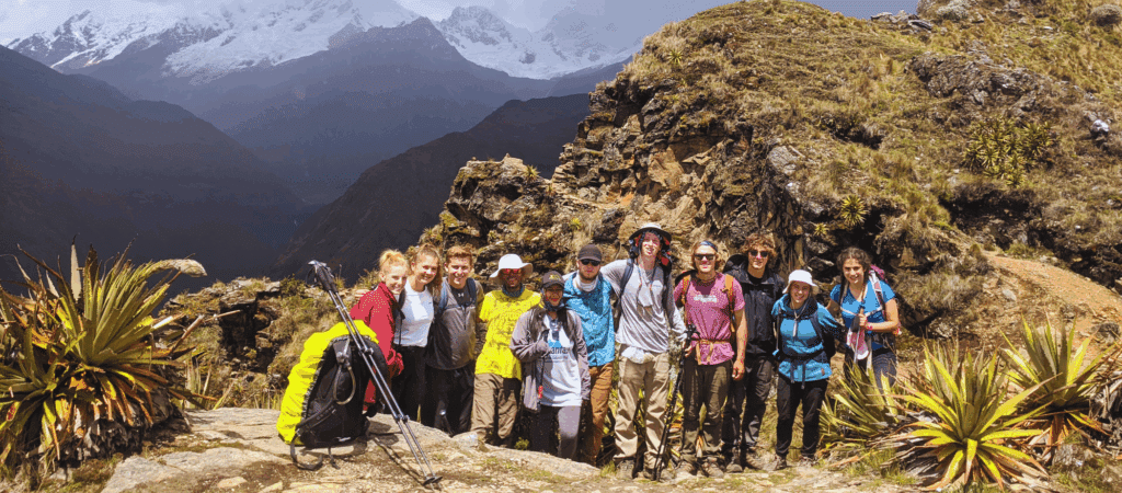 group smiling with mountains in the background