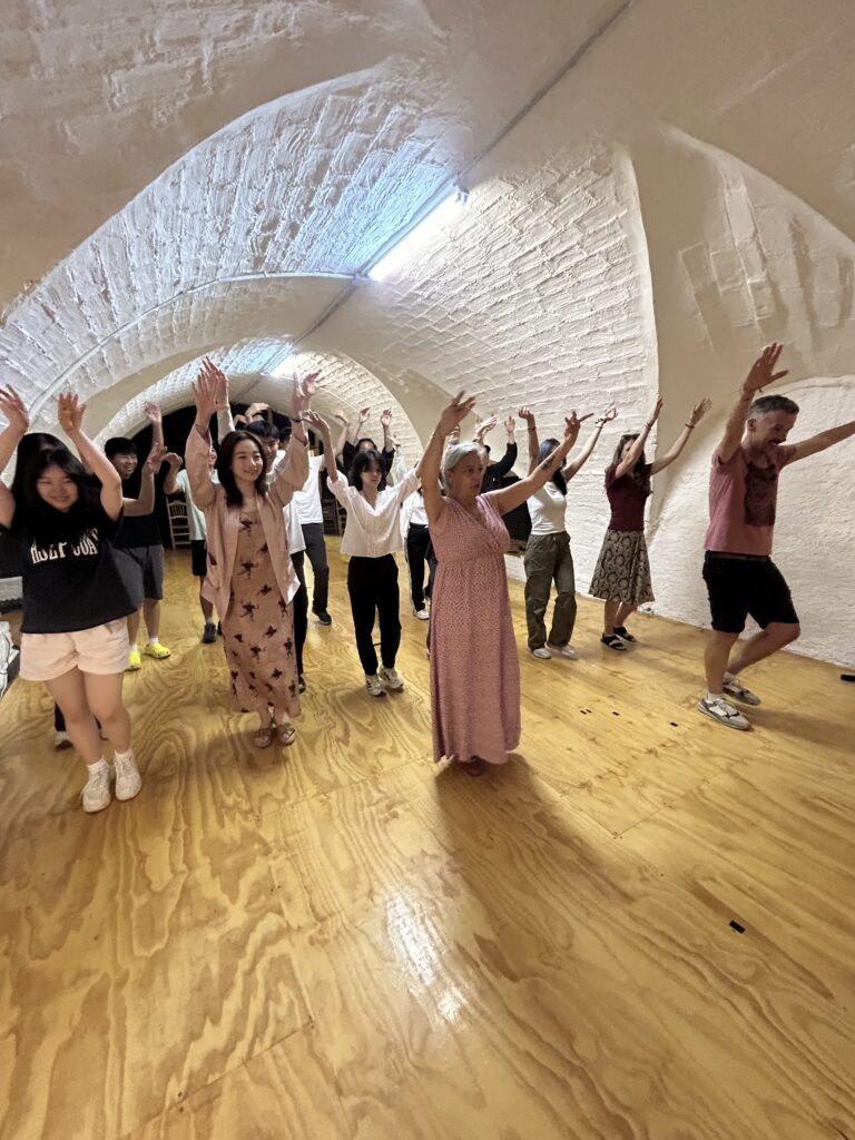 people learning to dance in arched room