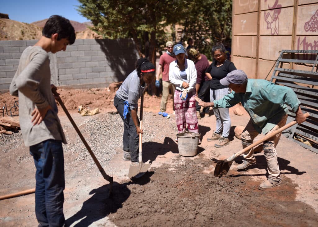 group mixing mud with shovels