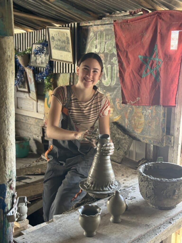 girl making pottery in small studio