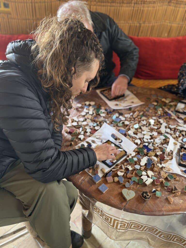 person making tile mosaic