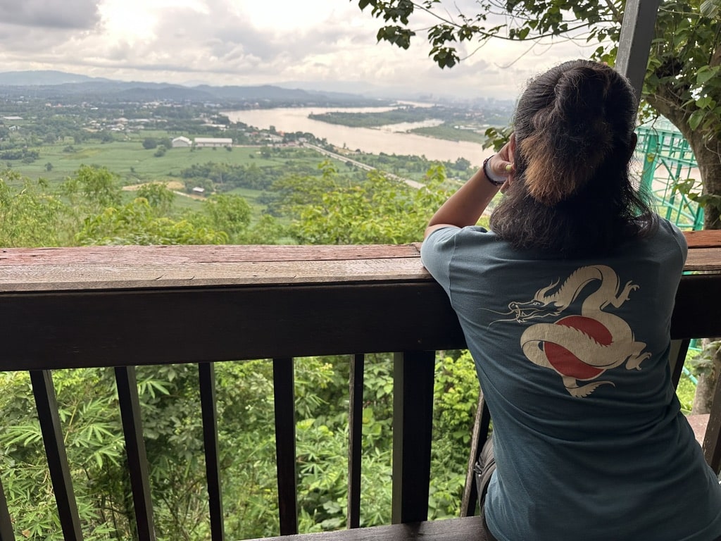 person looking out over river
