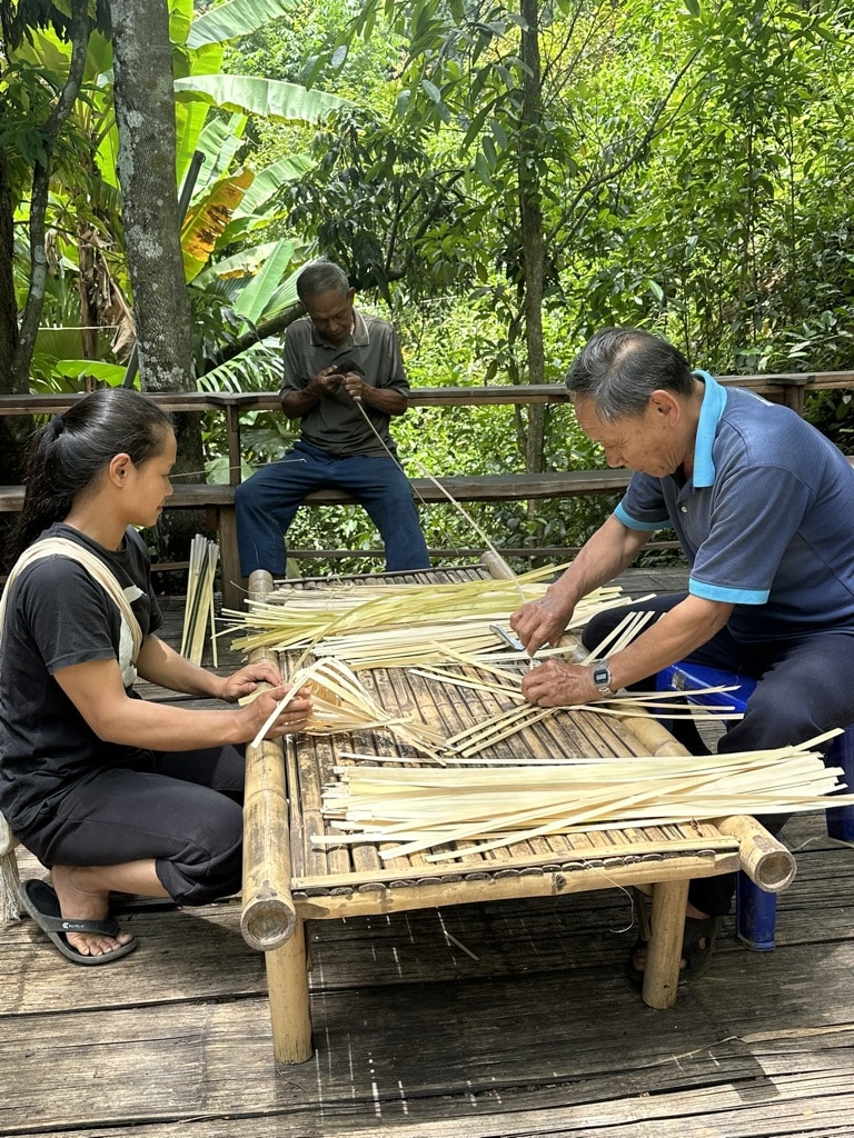 person learning to weave wood